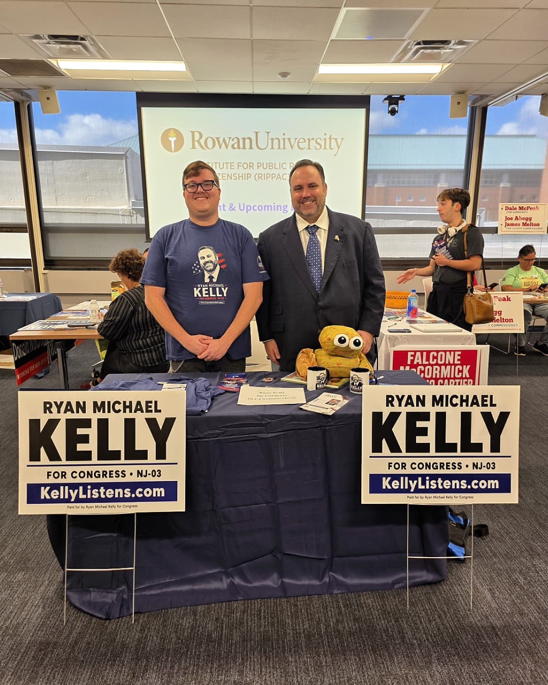Ryan Michael Kelly and Rowan student volunteer Ian stand behind the Kelly for Congress table at Rowan University's RIPPAC Political Campaign Volunteer Fair