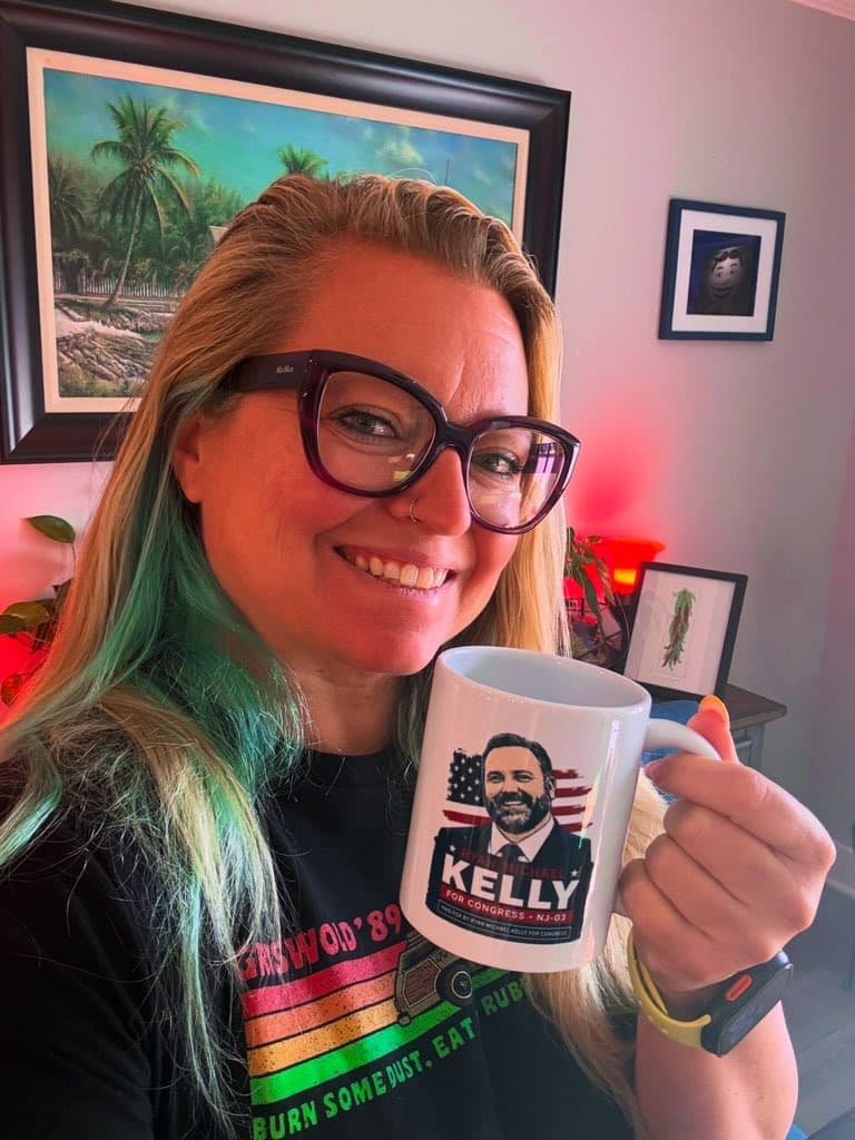 Kelly for NJ-03 supporter holding a campaign mug.